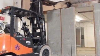 Bobcat moving wall in to place